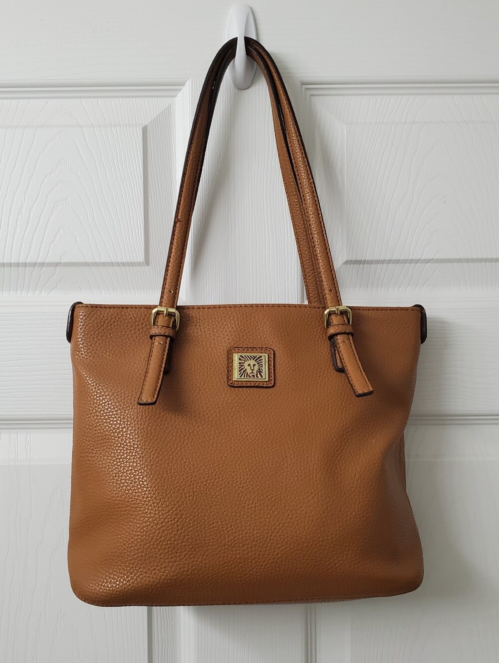 Anne Klein pebbled Tan leather shoulder tote bag with a gold-tone logo emblem.